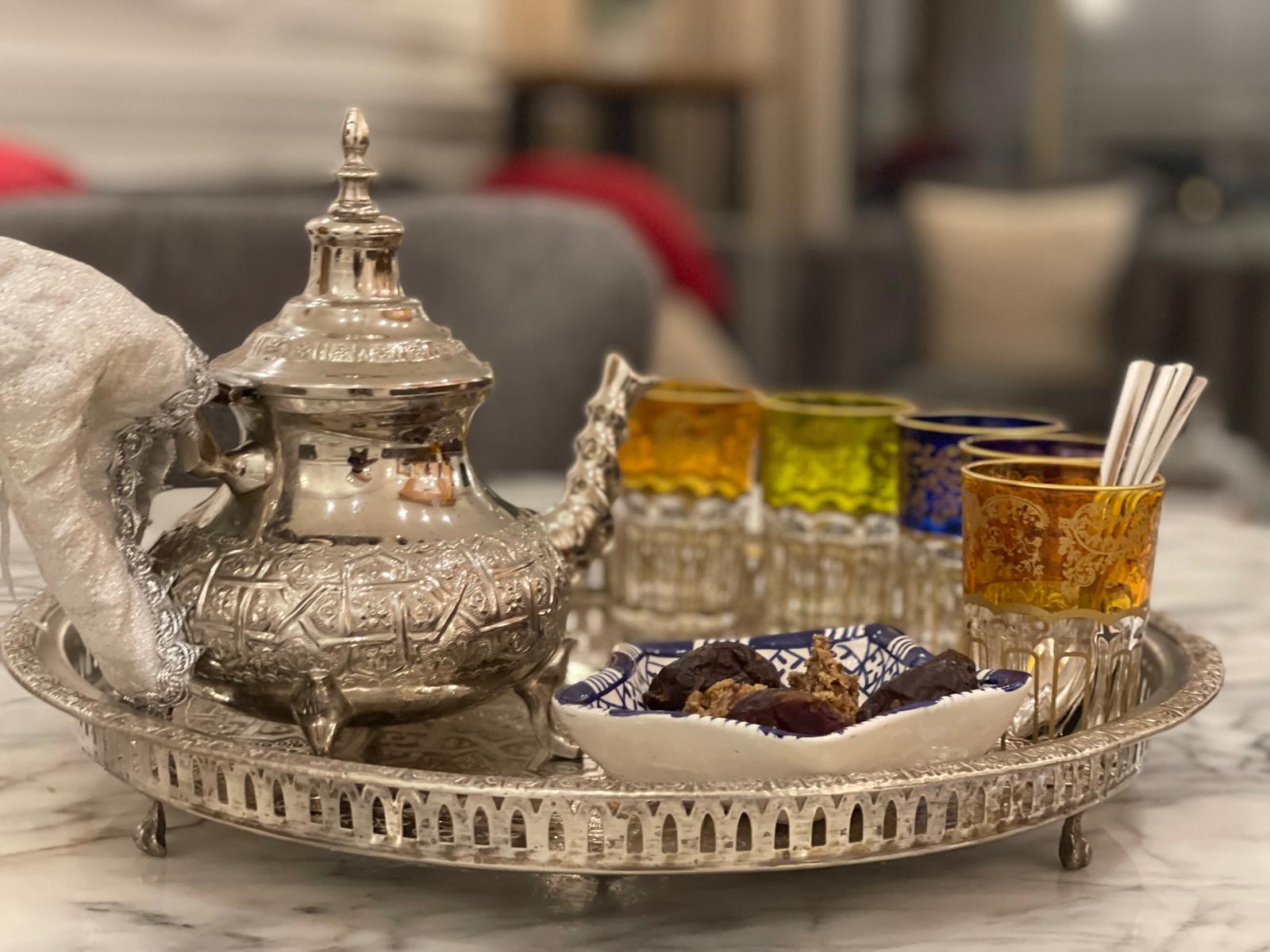 Moroccan silver tea service with colored glasses and dates